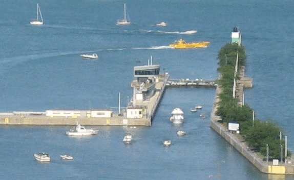 HDI Chicagoland Boat Cruise The Chicago Harbor Lock, also known as the Chicago River & Harbor Controlling Works, is a stop lock and dam located within the Chicago Harbor in Chicago, Illinois, at the mouth of the Chicago River. It is a component of the Chicago Area Waterway System, and is used to control water diversion from Lake Michigan into the river and for navigation. Courtesy https://en.wikipedia.org/wiki/Chicago_Harbor_Lock
