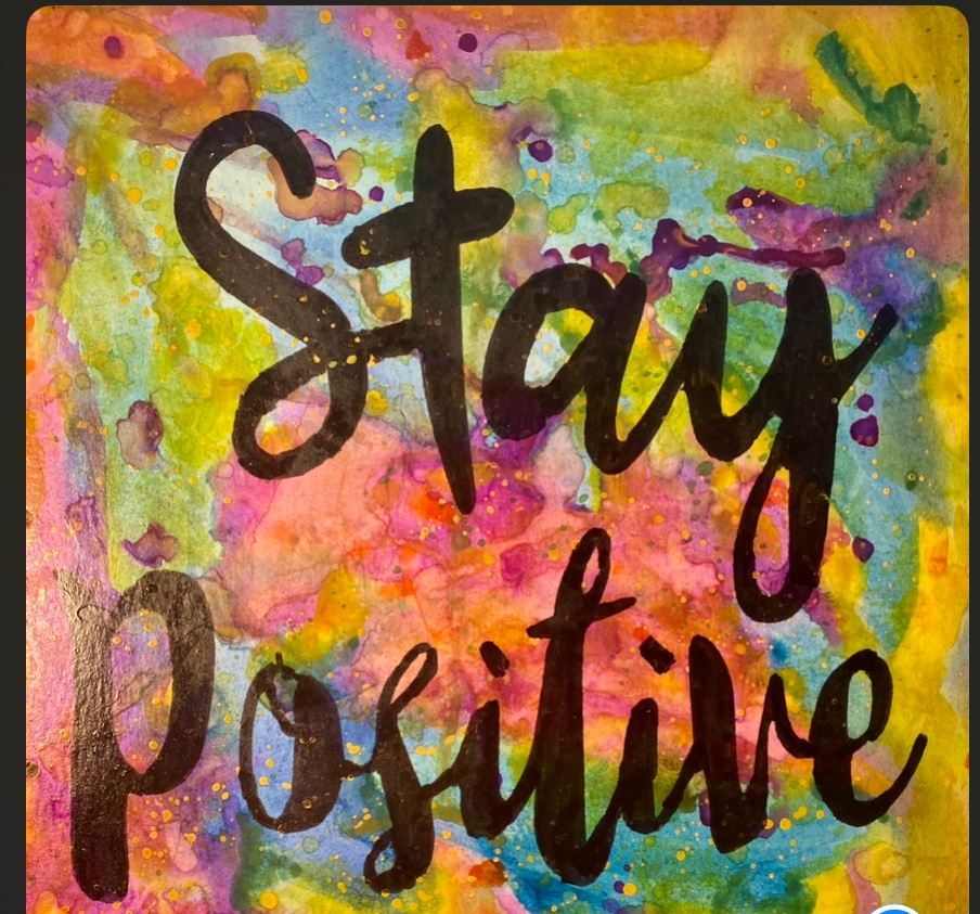 Listen to Your Mother! Carol Eacret Simmons- Stay Positive glows with color — oranges, pinks, greens — optimism that refuses to dim.